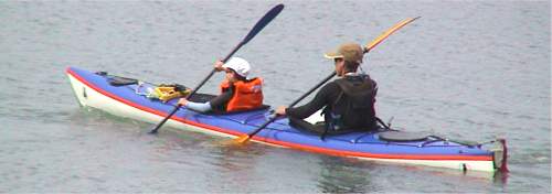 Adult and child in touring double kayak