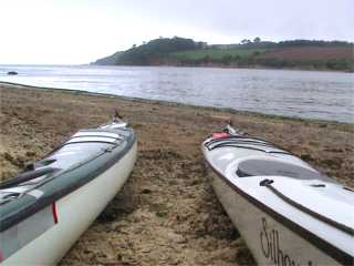 Two sea kayaks on beach