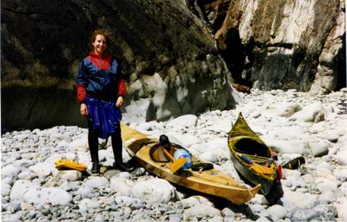 Kayaks on a boulder beach