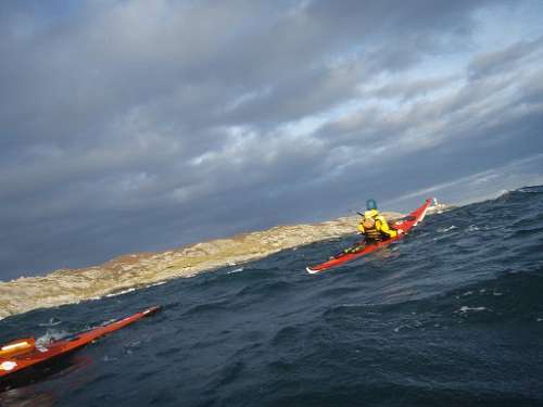 Kayakers rounding the point