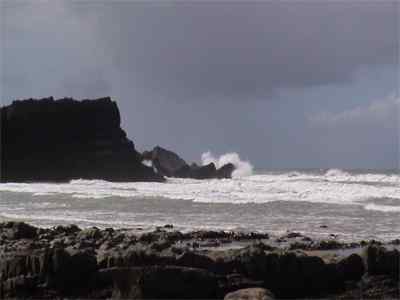 Big wave hitting headland