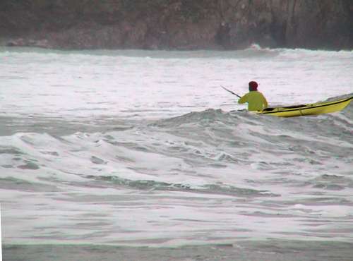 Sea kayak crossing over wave